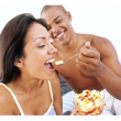 Young Couple Sharing Food in Bed