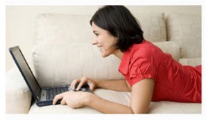 Woman on her laptop enjoying an online chat, now a standard communication method for socializing. 