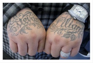 Mr Cartoon's tattoo artistry his own hands. His children's names. 