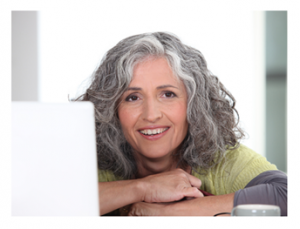 Woman working at computer and smiling