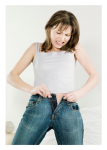 Woman struggling to close her jeans