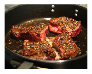 Steak searing on top of the stove