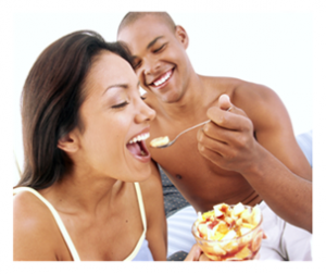 Young Couple Sharing Food in Bed