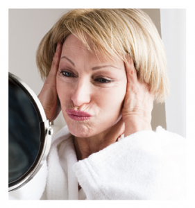 Mature Woman Making a Face in the Mirror