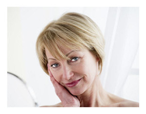 Mature Woman Looking at Herself in Mirror