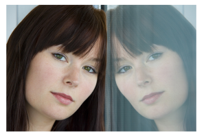 Woman Contemplating and Leaning Against Window