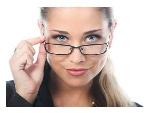 Young Businesswoman Peering Over Glasses