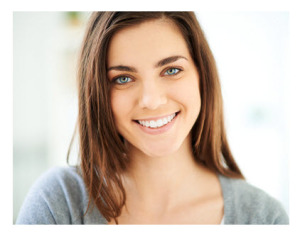 Happy Young Woman Smiling at Camera