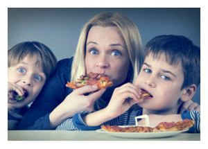 Mother and Sons Eating Pizza