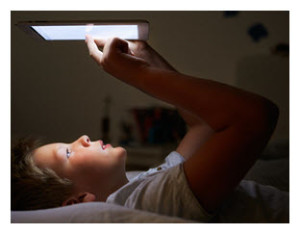 Boy with Tablet in Bed