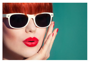 Woman with red hair red lips and sunglasses