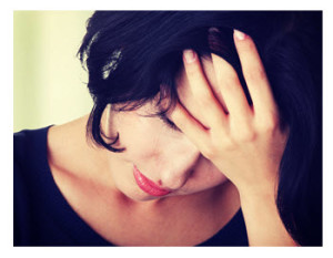 Sad Young Woman Holding Her Head in Her Hand