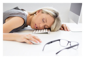 Exhausted Woman Asleep at Computer