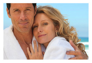 Happy Mature Couple at Beach in Bathrobes