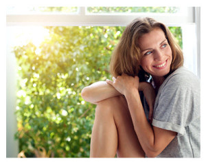 Smiling 40 Something Woman Sitting at Open Window