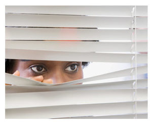 woman-looking-through-blinds