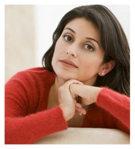 thoughtful-woman-sitting-on-her-couch